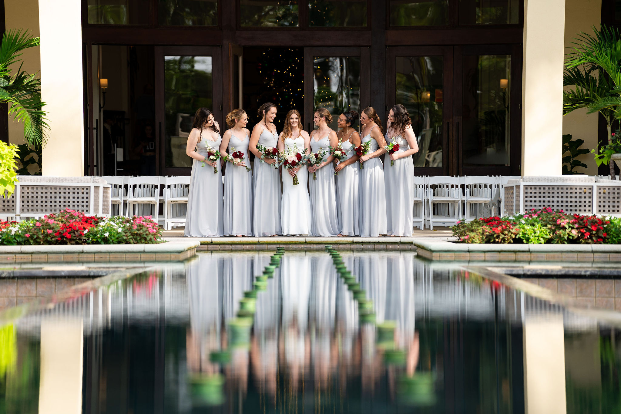 bride with bridal party reflection from pond