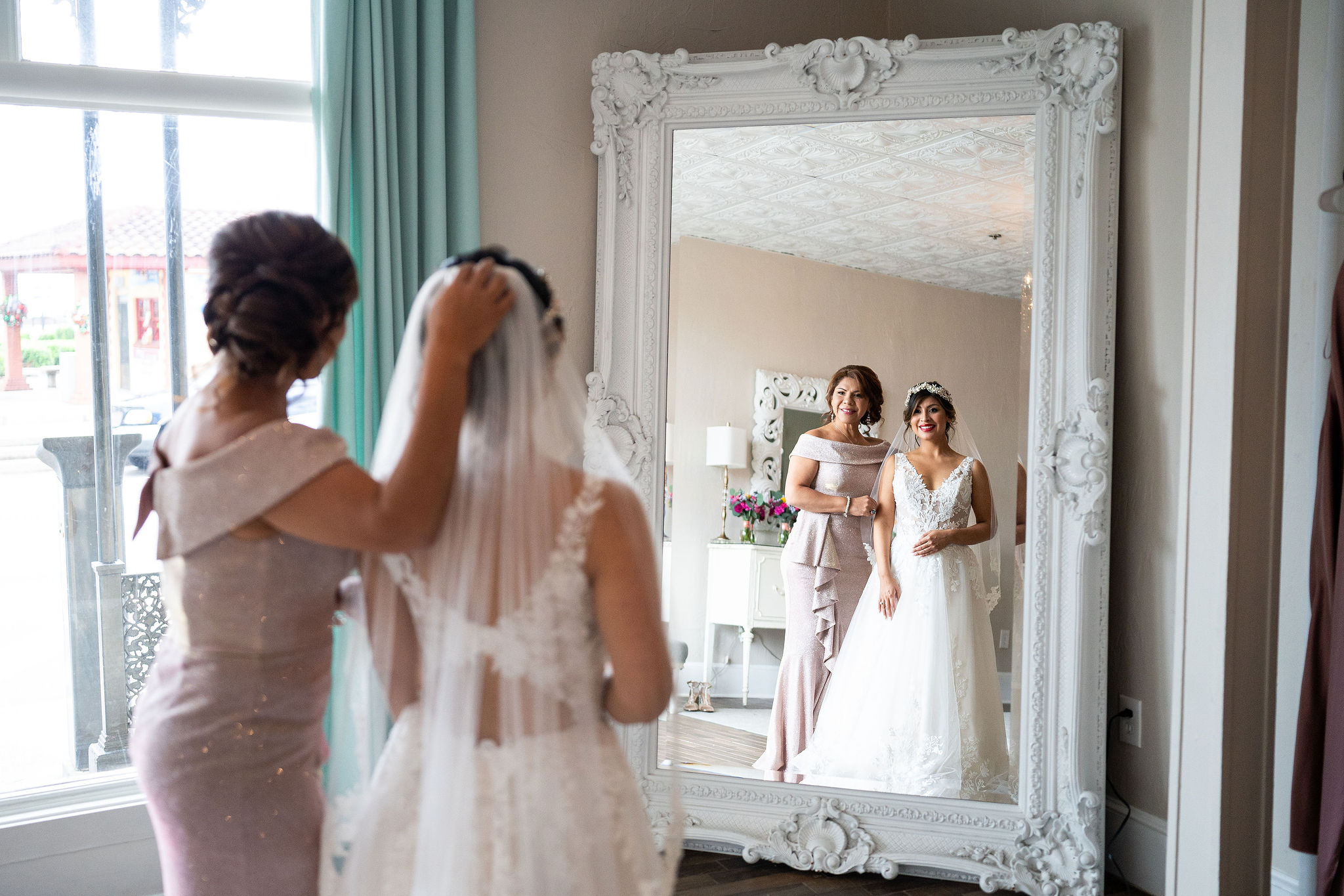 mother of the bride posing with her bride in a mirror