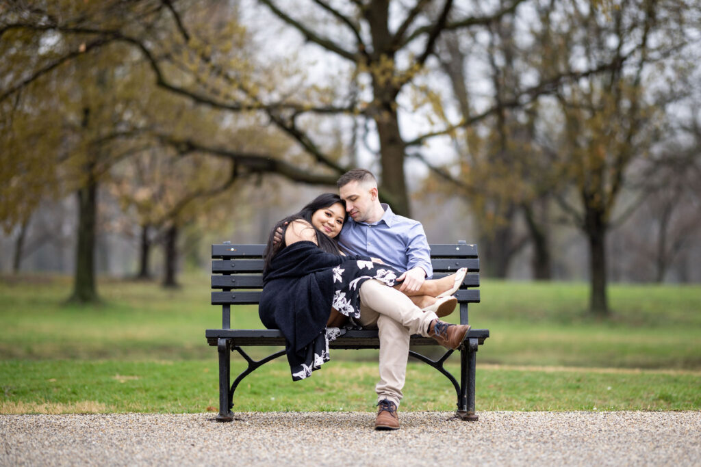 couple snuggling on a park bench in DC