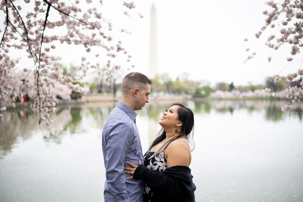 couple looking at each other in front of the Washington monument
