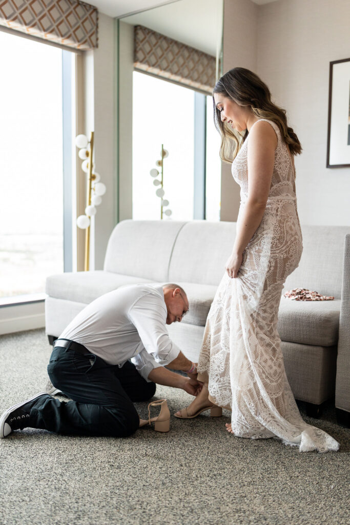 putting the brides shoes on